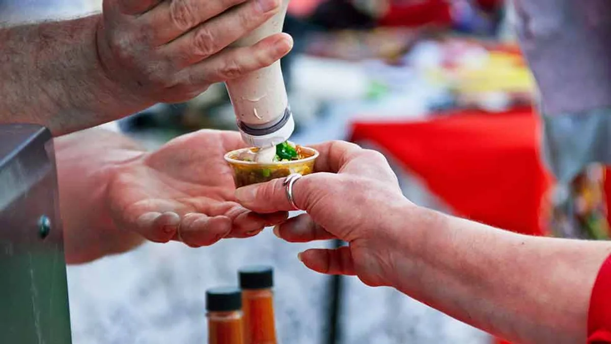 A food tasting sample being prepared and served