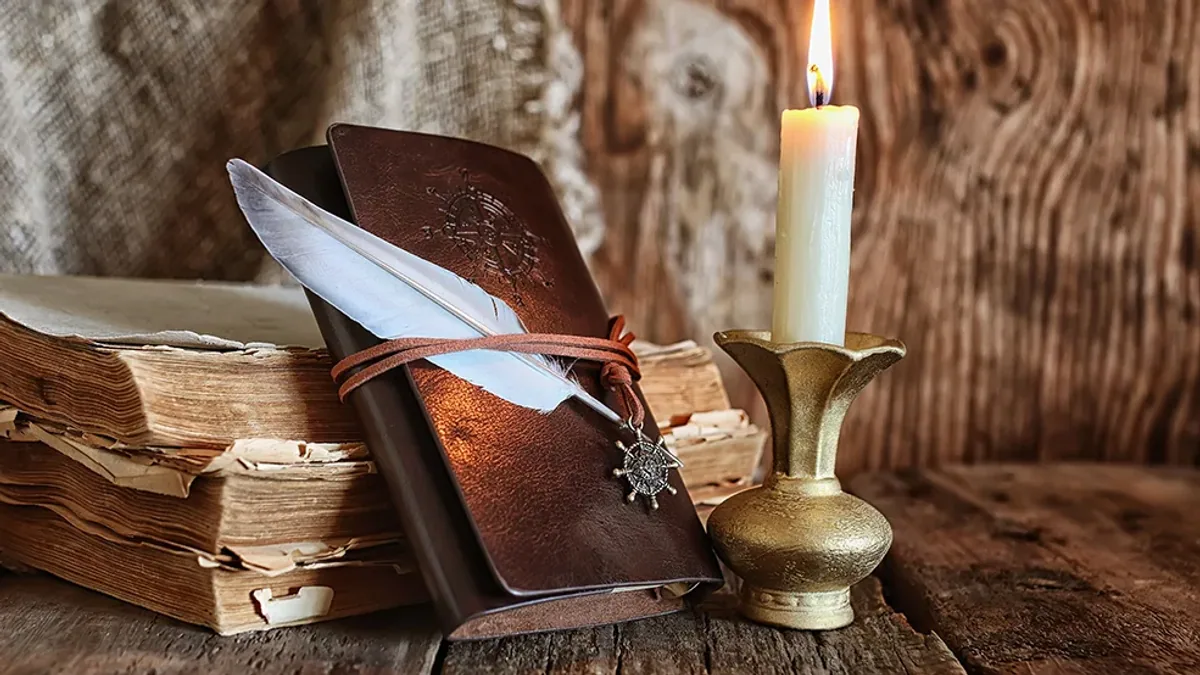An open book, quill and candle illustrating Beechwood’s Living Library