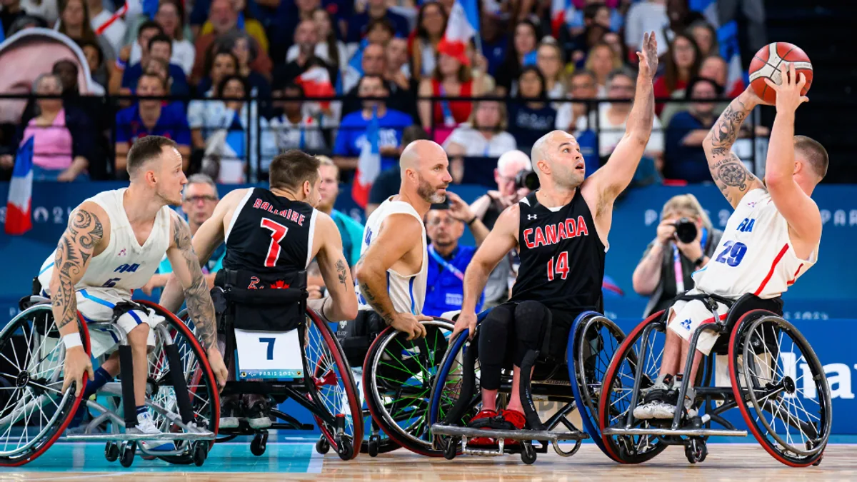 Canadian wheelchair basketball players defending against France