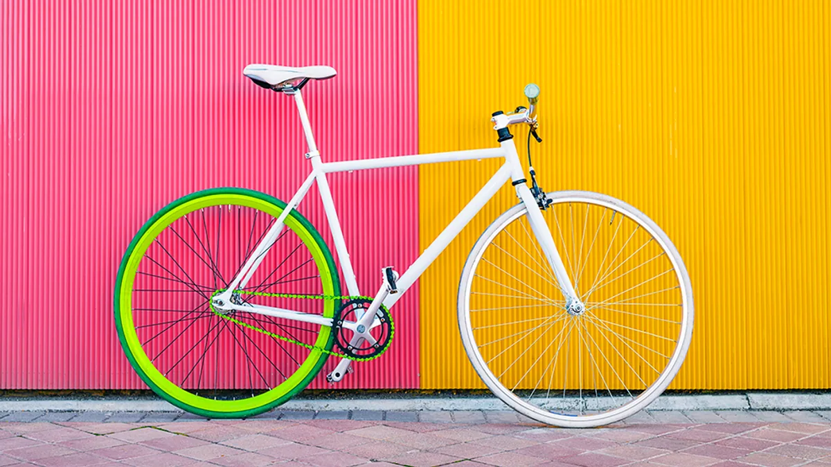A colourful bicycle against a bright wall
