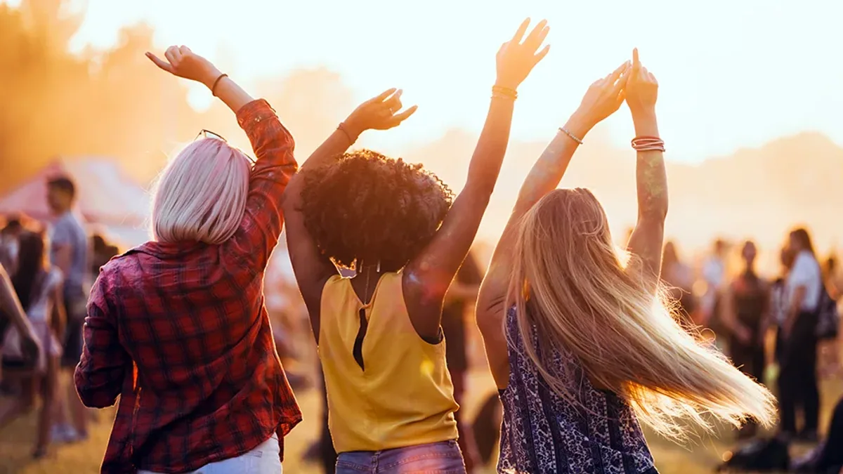 A crowd enjoying an outdoor music festival